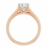 Detailed side view of a round moissanite ring showing the arched cathedral setting and split-shoulder design.
