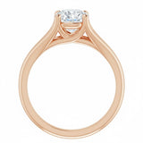 Detailed side view of a round moissanite ring showing the arched cathedral setting and split-shoulder design.