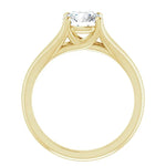 Detailed side view of a round moissanite ring showing the arched cathedral setting and split-shoulder design.