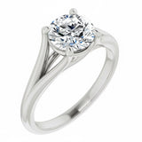 Close-up of a high-quality D-color VVS1 round moissanite in an elegant architectural gold setting.