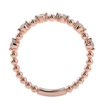Top-down view of a D-color VVS1 round stone half-eternity wedding band in rose gold.