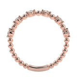 Top-down view of a D-color VVS1 round stone half-eternity wedding band in rose gold.
