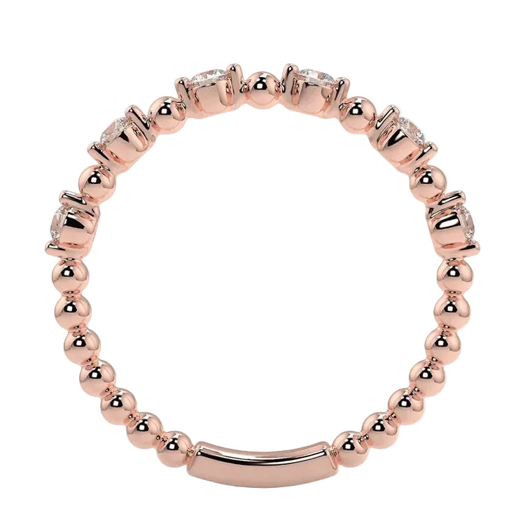 Top-down view of a D-color VVS1 round stone half-eternity wedding band in rose gold.