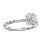 Close-up of a high-quality D-color VVS1 round moissanite secured by polished double cat-claw prongs.