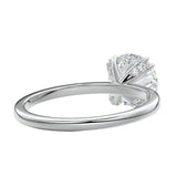 Close-up of a high-quality D-color VVS1 round moissanite secured by polished double cat-claw prongs.