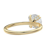 Close-up of a high-quality D-color VVS1 round moissanite secured by polished double cat-claw prongs.