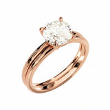 Four-prong round solitaire with a dainty polished shank and matching wedding ring in rose gold.