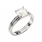 Four-prong round solitaire with a dainty polished shank and matching wedding ring in white gold.