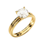 Four-prong round solitaire with a dainty polished shank and matching wedding ring in yellow gold.