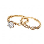 Organic nature-inspired moissanite bridal set with hand-set accent stones in solid yellow gold.