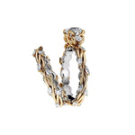 Round moissanite with symmetrical pear accents and a marquise interval wedding band in two-tone gold.