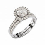 Diamond ring with a halo and side stones on a white background, featuring the ApolloGem brand.