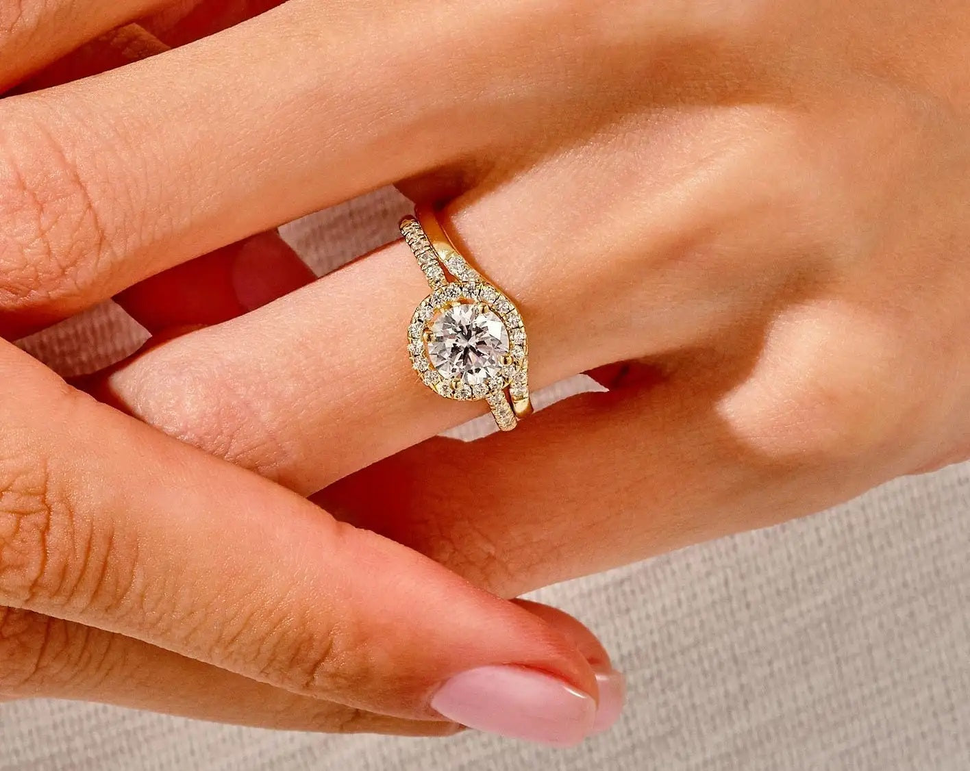 The Round Duo Halo Wave set on a finger showing the organic curved silhouette and unified fire.