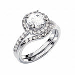 White gold moissanite bridal set with a round halo solitaire and asymmetrical pavé wedding ring.