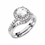 White gold moissanite bridal set with a round halo solitaire and asymmetrical pavé wedding ring.
