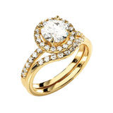 Yellow gold moissanite bridal set with a round halo solitaire and asymmetrical pavé wedding ring.