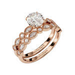 Rose gold moissanite bridal set with a round solitaire and matching vintage-style wedding band.