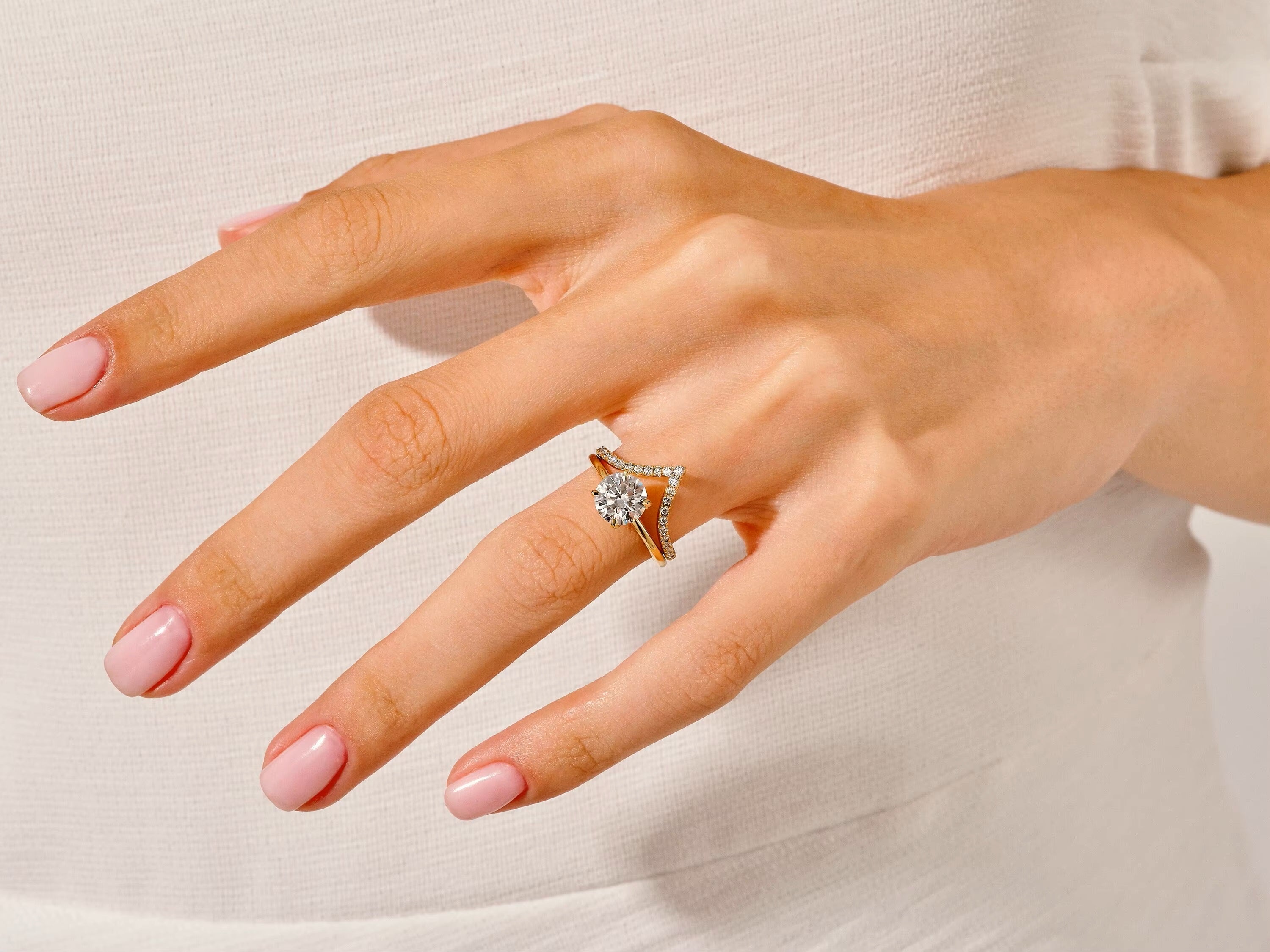 The Round Duo Leaf Accent set on a finger showing the elegant organic silhouette and fire.