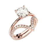 Four-prong round solitaire with decorative leaf-style shoulders and matching v-shaped band.