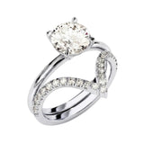 Four-prong round solitaire with decorative leaf-style shoulders and matching v-shaped band.