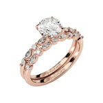 Round brilliant center stone with decorative multi-shape pavé shanks and matching wedding band.
