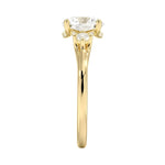Four-prong round engagement ring in 18k yellow gold featuring a unique pedestal frame design and premium stones