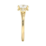 Four-prong round engagement ring in 18k yellow gold featuring a unique pedestal frame design and premium stones