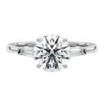 Top-down view of a symmetrical round brilliant ring with tapered baguettes on a polished 18k white  gold shank.