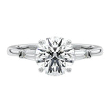 Top-down view of a symmetrical round brilliant ring with tapered baguettes on a polished 18k white  gold shank.