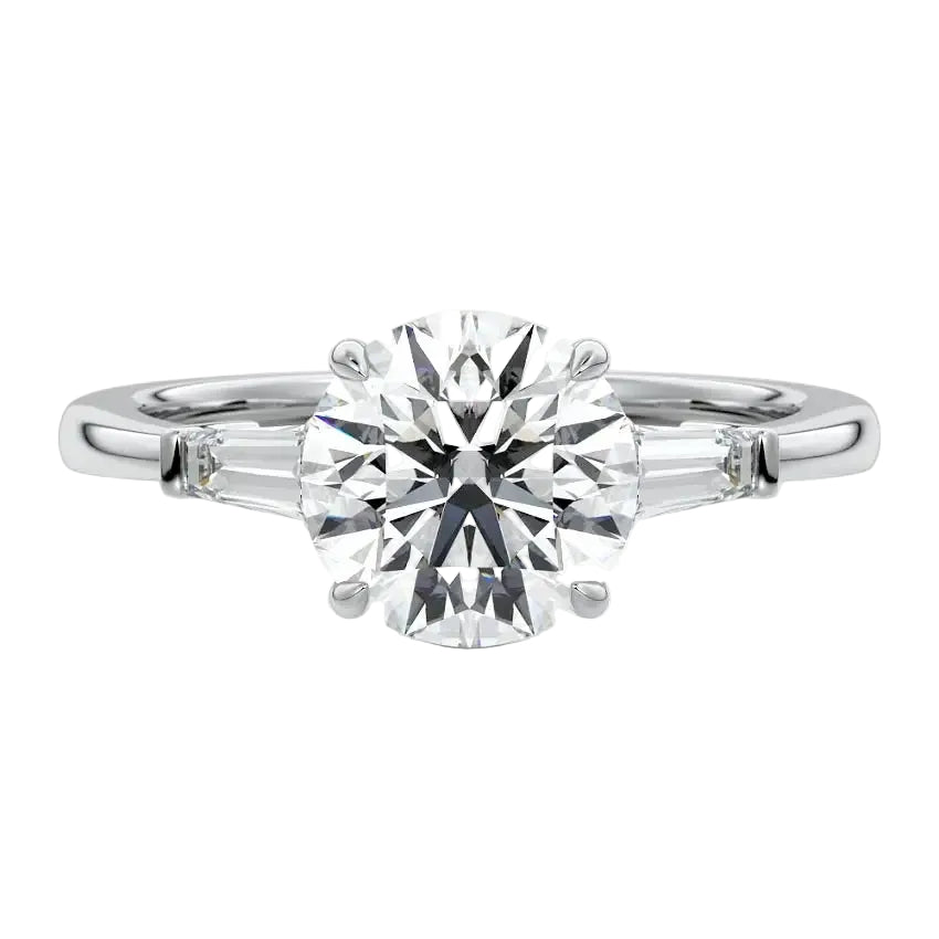 Top-down view of a symmetrical round brilliant ring with tapered baguettes on a polished 18k white  gold shank.
