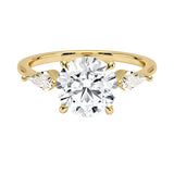 Luxury round brilliant moissanite engagement ring in yellow gold featuring structural kite cut side stone accents ApolloGem South Africa.