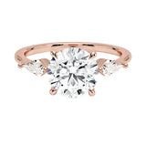Luxury round brilliant moissanite engagement ring in rose gold featuring structural kite cut side stone accents ApolloGem South Africa.