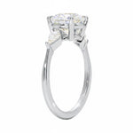 Detailed side view of a round moissanite ring showing the secure four-prong setting and geometric kite-shaped side stones.