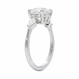 Detailed side view of a round moissanite ring showing the secure four-prong setting and geometric kite-shaped side stones.
