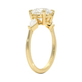 Gold ring with three diamonds on a white background