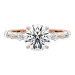 Close-up of a high-quality D-color VVS1 round brilliant moissanite center stone with asymmetrical accents guaranteed by a GRI certificate.