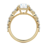 Top-down view of a round moissanite ring with floating side accents on a polished yellow gold comfort-fit shank.