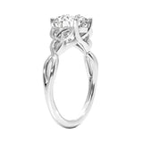 Close-up of a D-color VVS1 round moissanite secured in a decorative twisted gold setting.