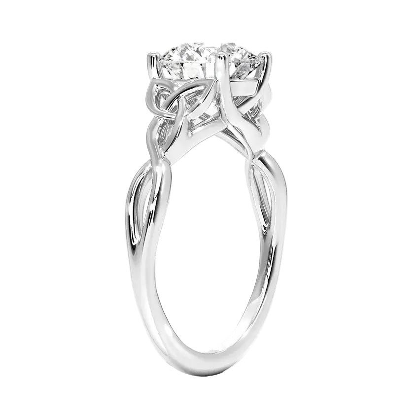 Close-up of a D-color VVS1 round moissanite secured in a decorative twisted gold setting.