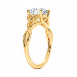 Close-up of a D-color VVS1 round moissanite secured in a decorative twisted gold setting.