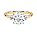 Luxury round brilliant moissanite engagement ring in yellow gold with two elegant pear cut side stone accents ApolloGem South Africa.