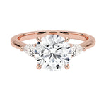 Luxury round brilliant moissanite engagement ring in rose gold with two elegant pear cut side stone accents ApolloGem South Africa.