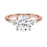 Luxury round brilliant moissanite engagement ring in rose gold with two elegant pear cut side stone accents ApolloGem South Africa.