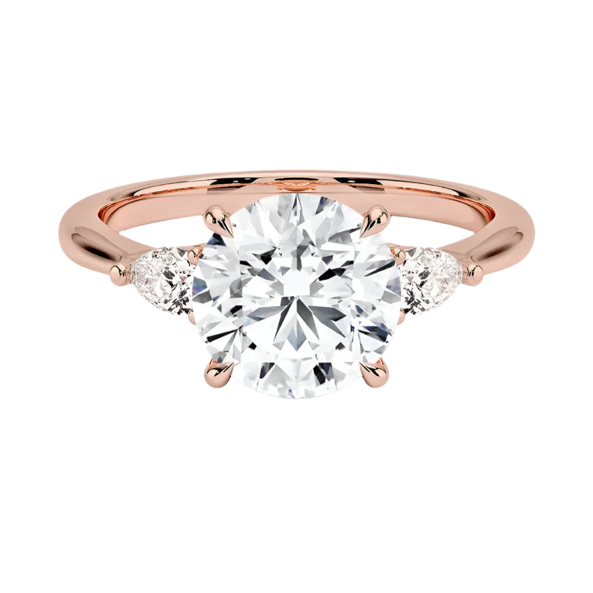 Luxury round brilliant moissanite engagement ring in rose gold with two elegant pear cut side stone accents ApolloGem South Africa.