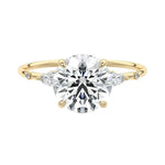Round brilliant moissanite engagement ring yellow gold marquise side stones nature inspired