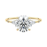 Round brilliant moissanite engagement ring yellow gold marquise side stones nature inspired