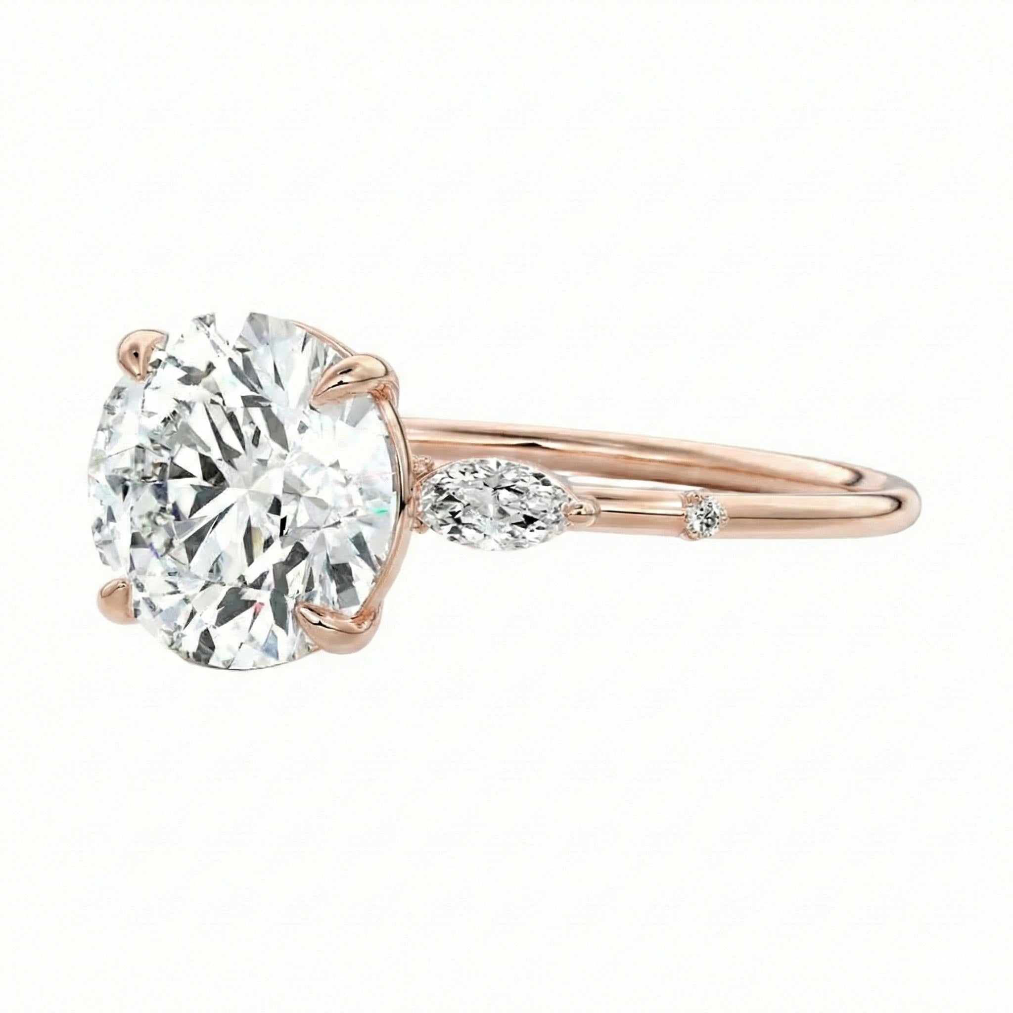 Gold ring with a large diamond and smaller diamond on a white background