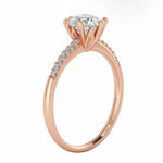 Top-down view of a D-color VVS1 round stone in a rose gold six-prong pavé setting.