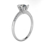 Top-down view of a D-color VVS1 round stone in a white gold six-prong pavé setting.