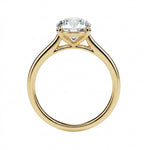 Symmetrical top-down view of a round moissanite solitaire in a polished solid gold setting.